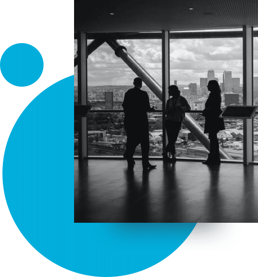 Black and white image of employees infront of a window